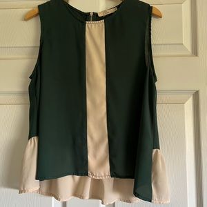 Dark green and cream sleeveless blouse.